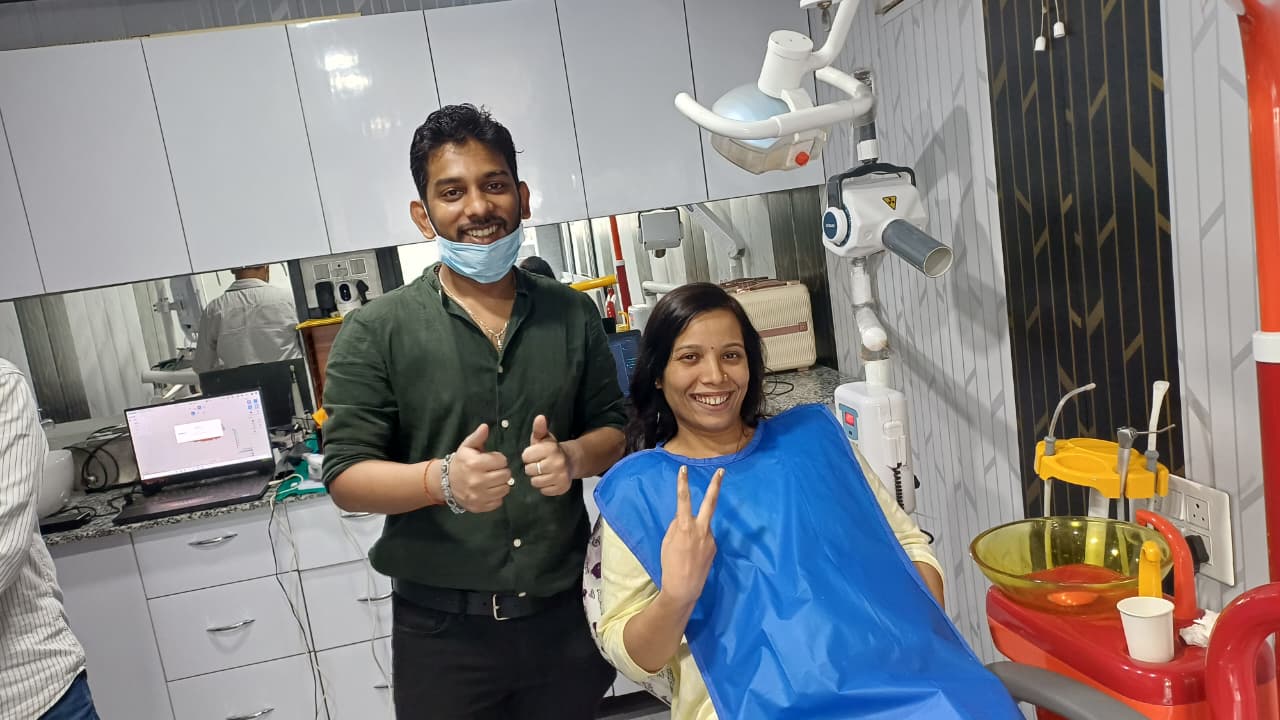 An adult patient smiling in the dental chair beside Dr. Rangan Ghosh after treatment at Tiny Tooth Dental, Lucknow