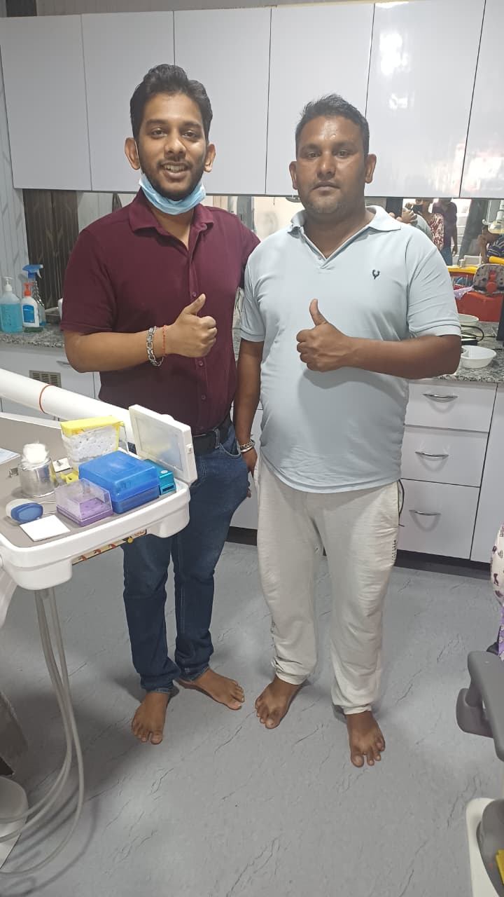 Dr. Rangan Ghosh and an adult patient giving a thumbs up after completing dental treatment in Lucknow